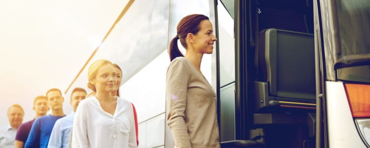 Row of people getting on bs